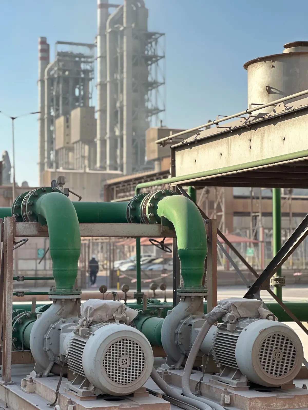 Industrial pumps and electric motors at a processing plant