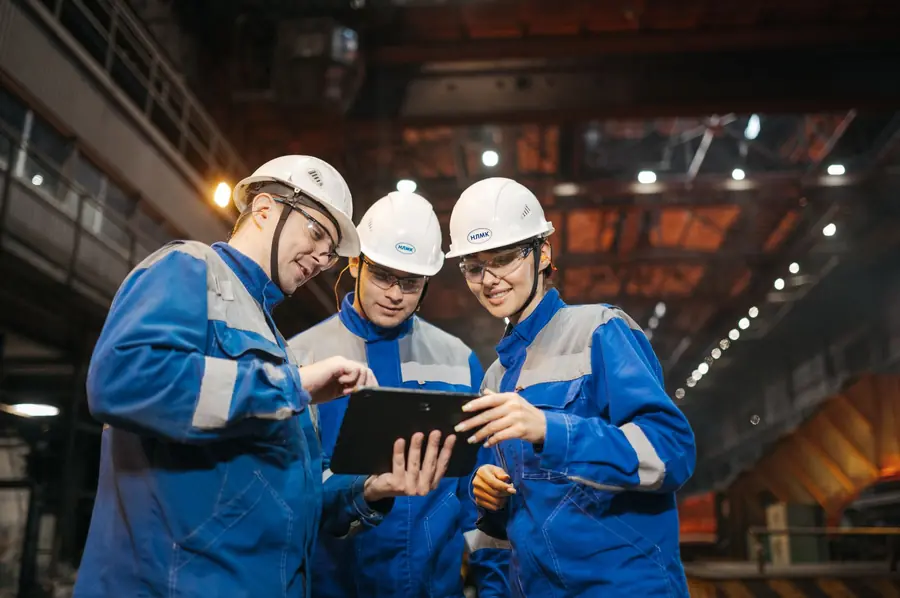 Engineers reviewing information on a tablet in a factory