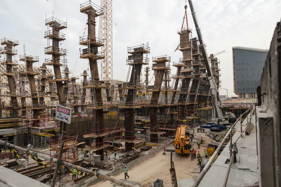 Construction site with steel framework and cranes
