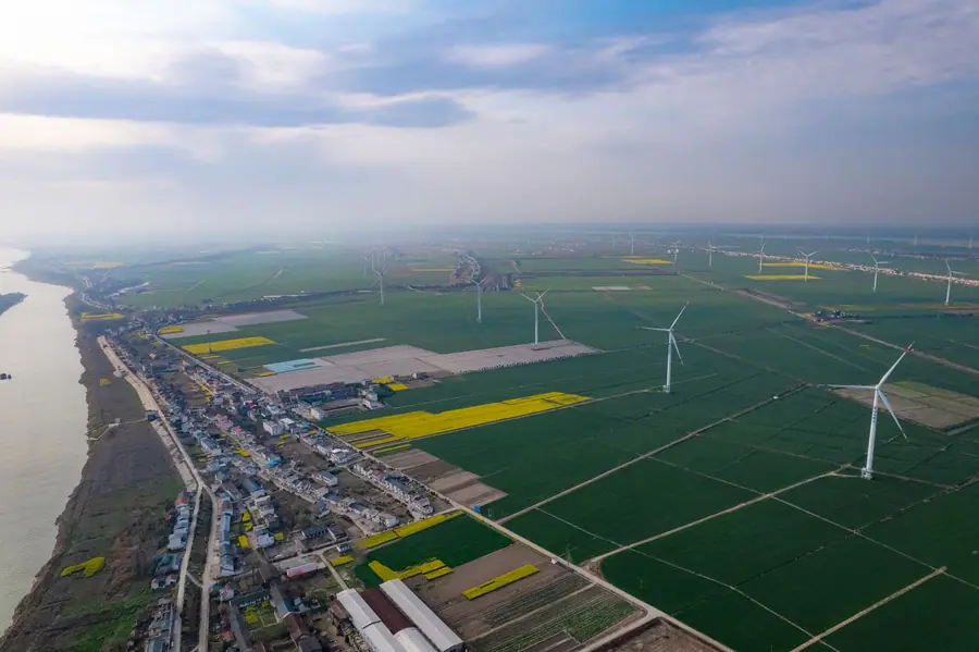 Aerial view of wind turbines across farmland