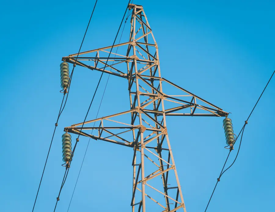 High-voltage transmission pylon against a clear sky